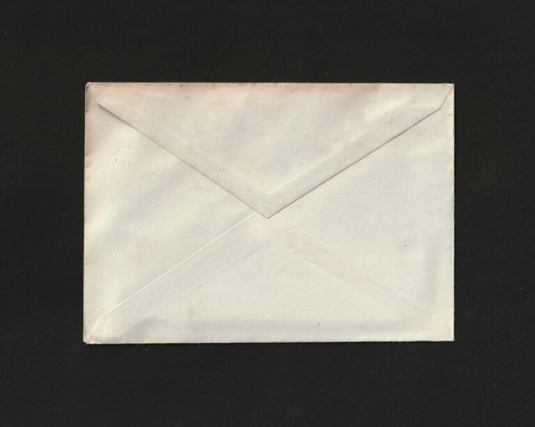 A paper envelope against a dark background.