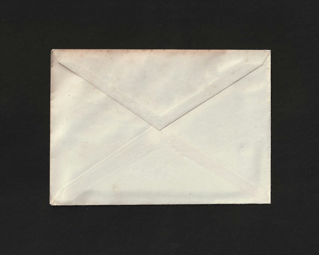 A paper envelope against a dark background.
